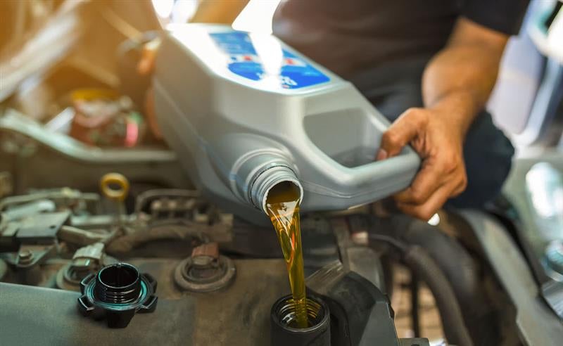 Chevrolet Certified Service technician checking engine oil